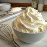A close-up image of a slice of creamy no-bake cheesecake on a plate, with a fork next to it, illustrating the perfect texture achieved with the right ingredients.