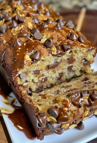 Sliced pumpkin bread with chocolate chips and nuts on parchment paper.